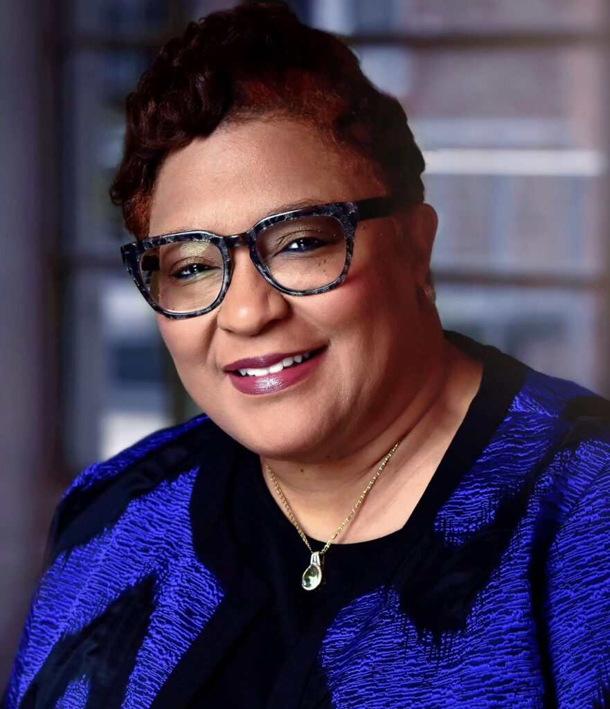 Close portrait of Commissioner Moore-Zeigler smiling in a blue jacket